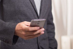 A photo of a person using a mobile phone at work